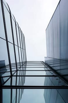 The photograph of the glass façade of a modern building by means of a lower view.