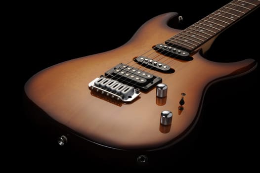 close up of a electric guitar on dark background