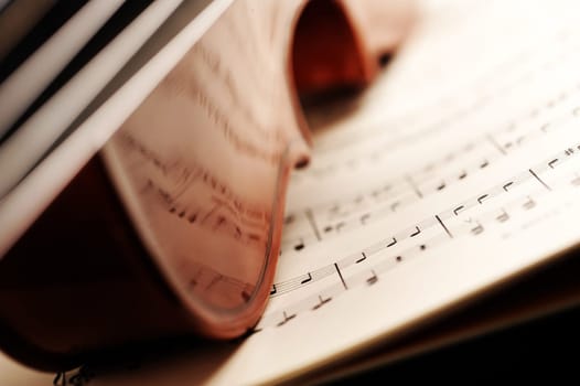violin on a music sheet, shallow deep of field