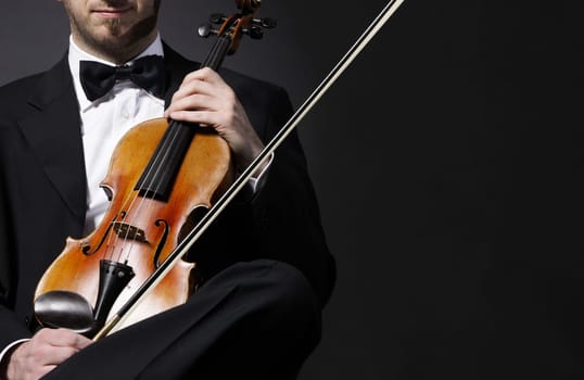 an elegant violinist with his violin