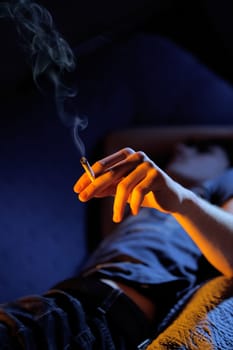Close up of teenage boy smoking drugs, copy space