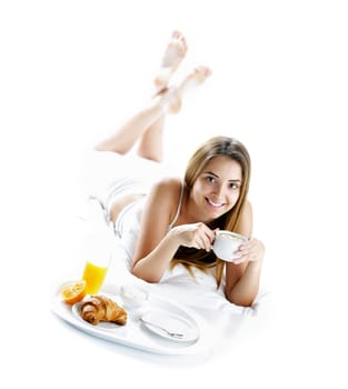 Young beautiful woman having breakfast in bed.