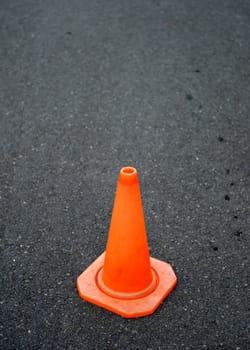 A close up shot of a safety cone on a road