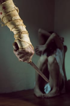 Scared woman threatened by a man with bloody knife
