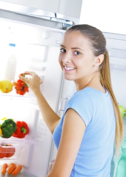Young woman takes a a strawberry