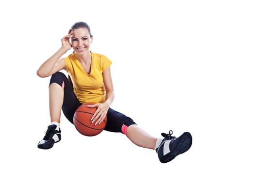 Isolated young beautiful girl in athletic wear with basketball