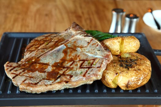 Grilled beefsteak served with fried potatoes