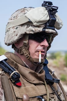 US marine smoking a cigarette half-turned to the camera