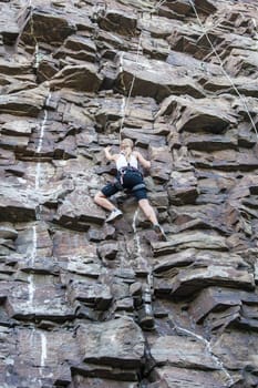 Extreme rock climber reaching for the summit