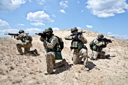 Squad of soldiers in the desert during the military operation