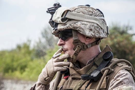 US marine smoking a cigarette half-turned to the camera