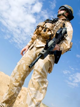 British Royal Commando in desert uniform holding his rifle