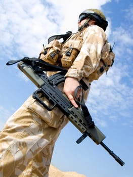 British Royal Commando in desert uniform holding his rifle