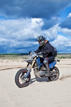 Enduro bike rider driving across the desert