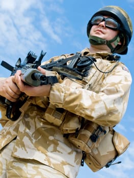 British Royal Commando in desert uniform holding his rifle