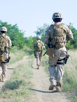 us soldiers with assault rifles on patrol