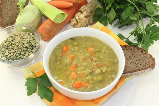 a white bowl with pea stew and parsley