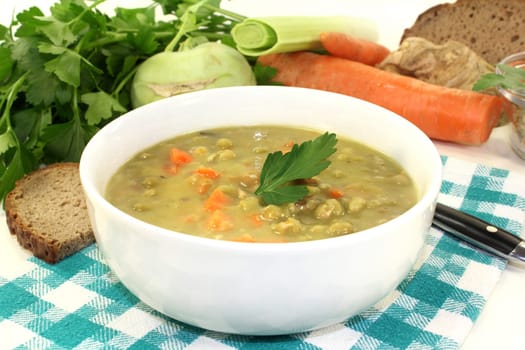a white bowl with pea stew and parsley