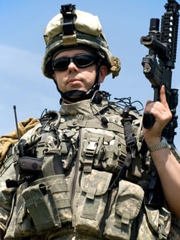 US soldier in camouflage uniform with his rifle
