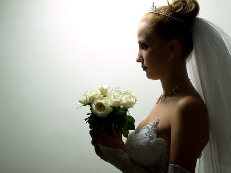 Beautiful bride portrait with flowers in her hand
