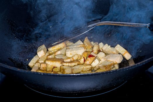 Tofu in wok.