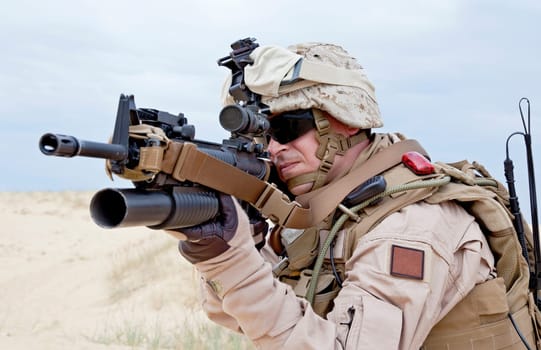 US marine aiming a gun with grenade launcher