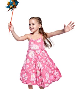 pretty little girl playing with pinwheel