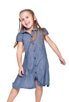 Laughing little girl dancing on the white background