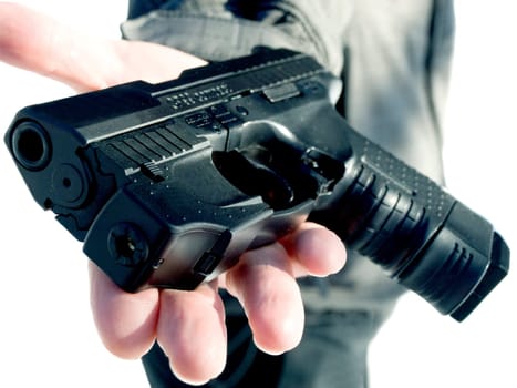 man's hand offering the gun