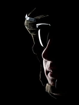 US soldier in the helmet on the black background