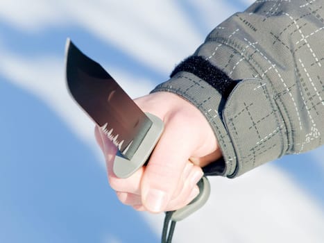 A male hand holding a large knife