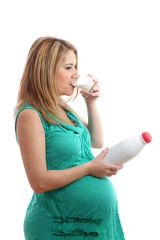 Details of a pregnant woman with a glass and a bottle of milk isolated on white background.