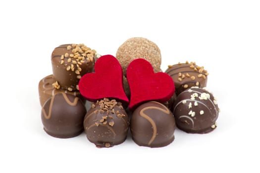 delicious chocolate and hearts on white background