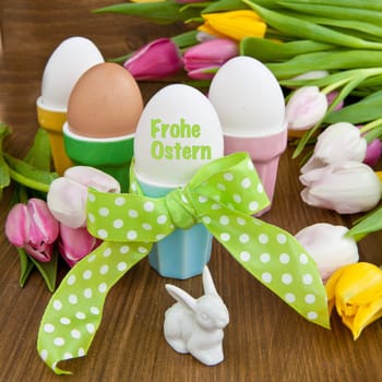 Colorful eggs and tulips at Easter