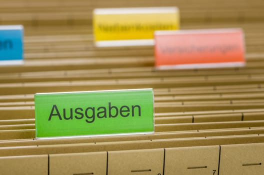 Hanging folders labeled Outputs