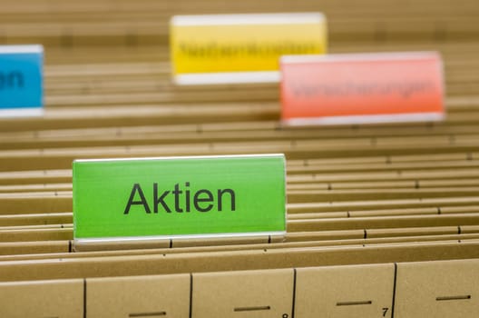Hanging folders with the inscription Shares