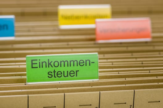 Hanging folders with the inscription Income Tax