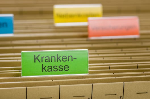 Hanging folders with the label Health Insurance