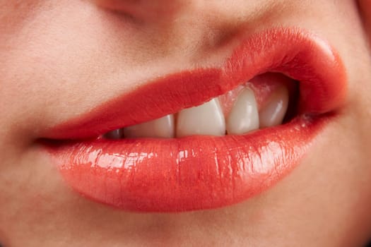 close-up of woman with red lipstick sneering at camera