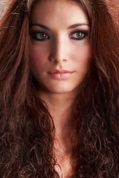 Portrait of beautiful young woman with make-up on grey background