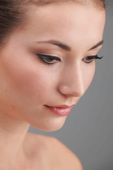 Young womans face with subtle make up and eye lash extensions