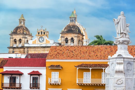Colorful colonial buildings with the church of San Pedro Claver in the background in the historic center of Cartagena, Colombia