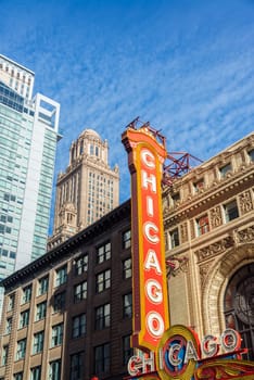View of the Chicago Theater marquee with skyscrapers visible in the background