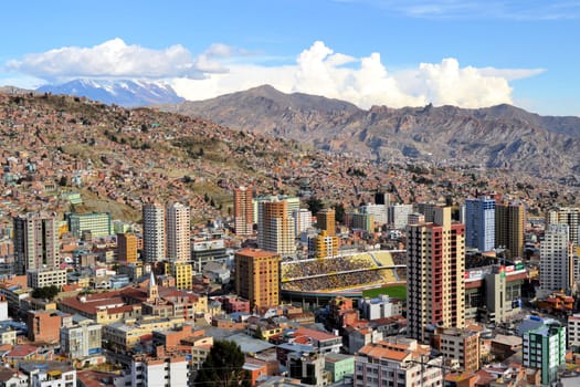 Aerial view of the city of La Paz, Boliva with Mt. Illimani as a backdrop during a soccer game in the stadium