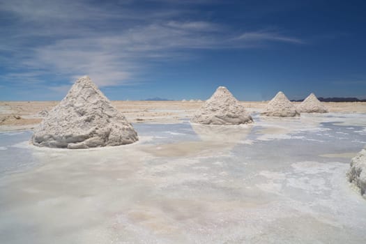 Heap of sea salt in a Bolivian salt flat prepared for harvest