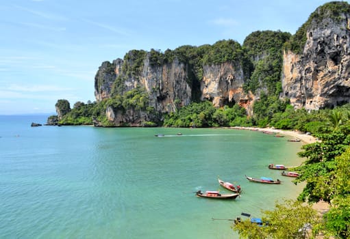 Ton Sai Beach on a sunny day with longtail boats as soon from a climbing wall