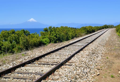 Railroad in front of volcaon Osorno and lake Llanquihue near Puerto Varas, Chile