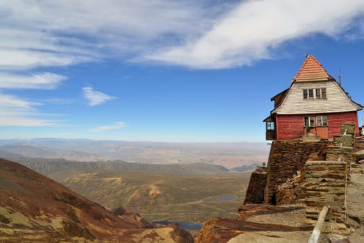 A house sitting high on the edge of rocky cliffs overlooking La Paz at the world's highest ski resort Chacaltaya, Bolivia, South America