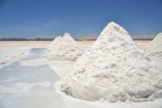 Heap of sea salt in a Bolivian salt flat prepared for harvest