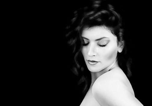 Beautiful young girl with closed eyes on a black background